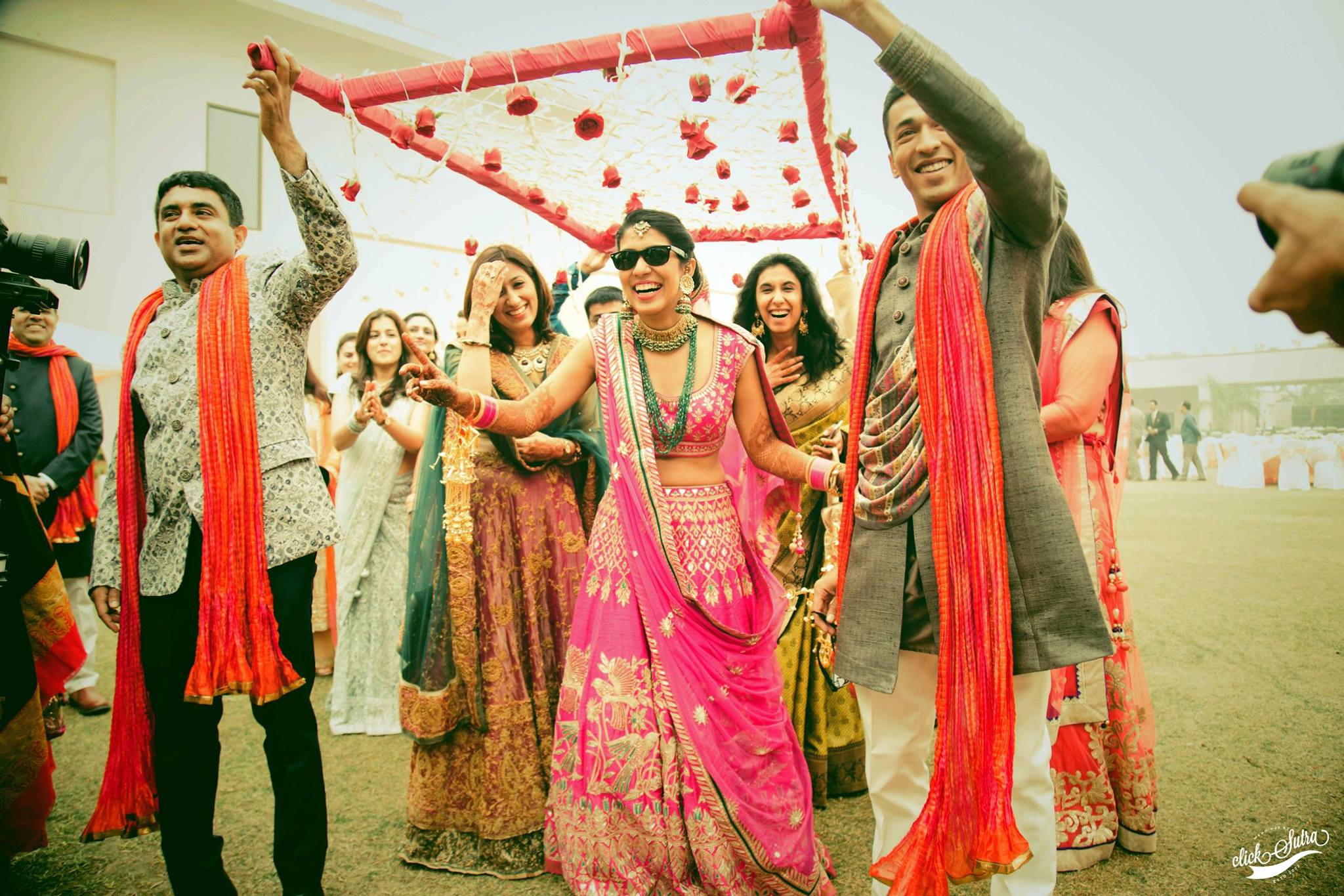 bride entry, bridal entry, fun bridal entry, bride wearing sunglasses, bridal lehenga, pink lehenga 