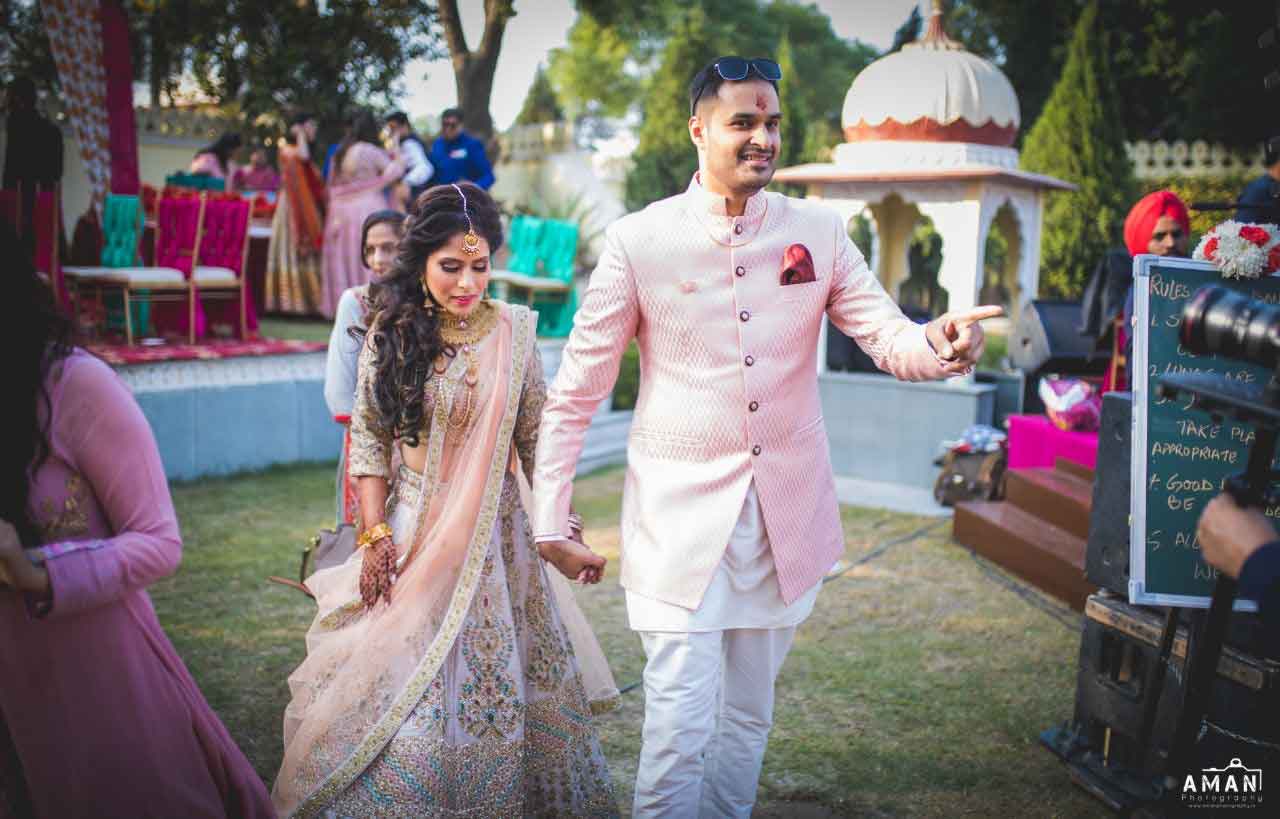 Colour Coordinated Couple Outfit Ideas, bridal outfit ideas, groom outfit ideas, pink bridal lehenga, peach bridal lehenga, sherwani ideas, groom accessories, bridal jewellery