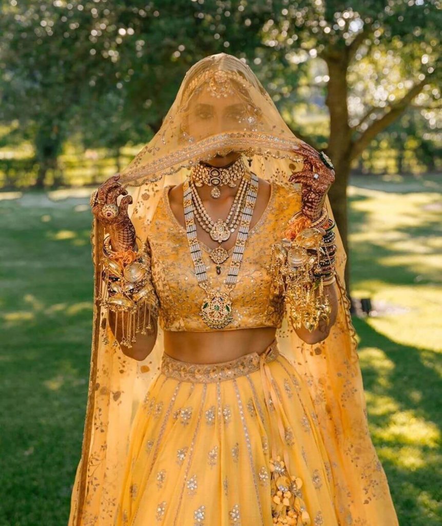 WedAbout on Instagram: “Bride looks stunning in yellow @sabyasachiofficial  lehenga paired with … | Trendy blouse designs, Bridal makeup looks, Indian  bridal fashion