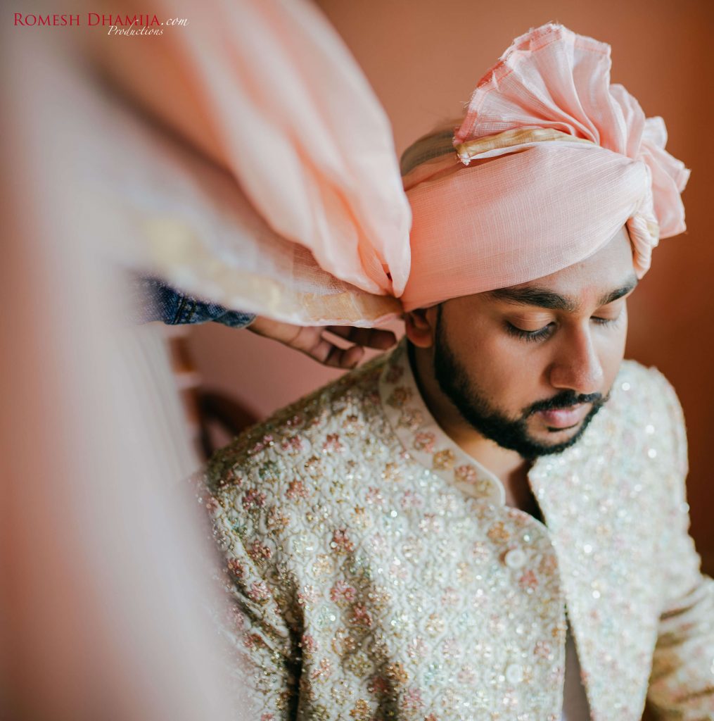 groom wearing safa poses