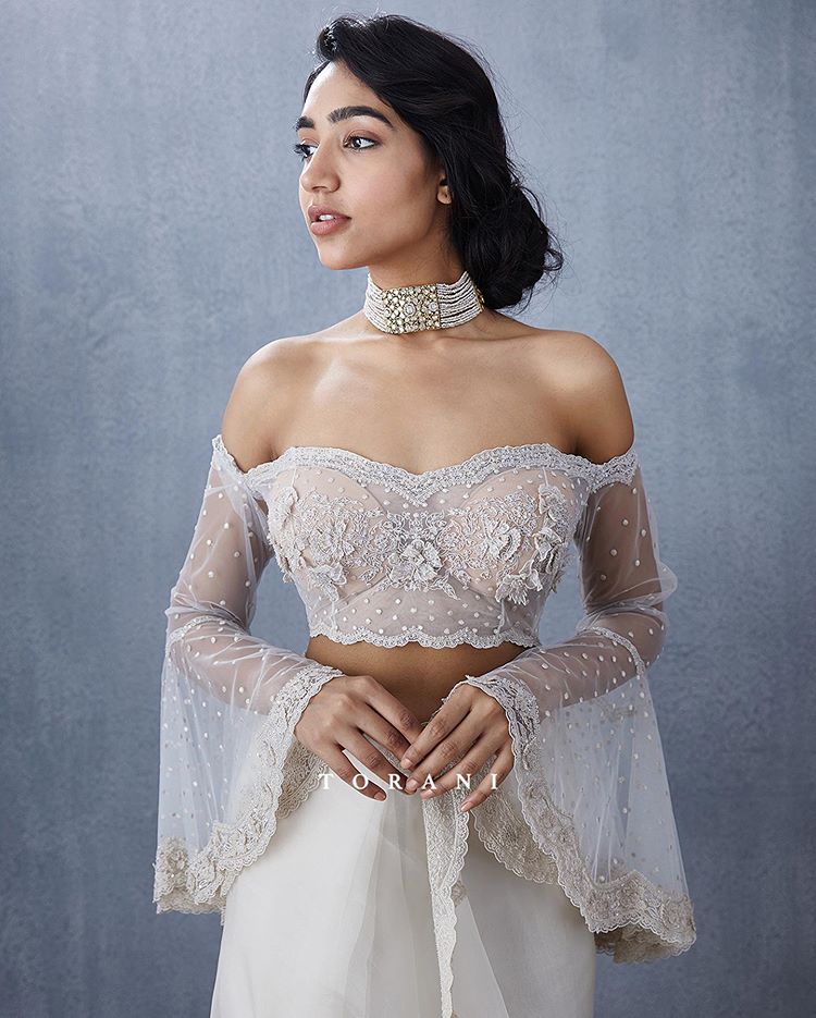 Delicate white lace designs on blouse