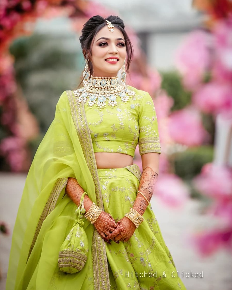 Bride wearing lime green lehenga