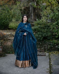 Deep teal lehenga with gold border