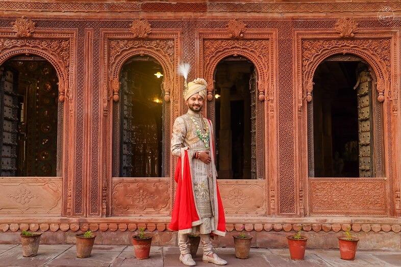 groom sherwani with red stole