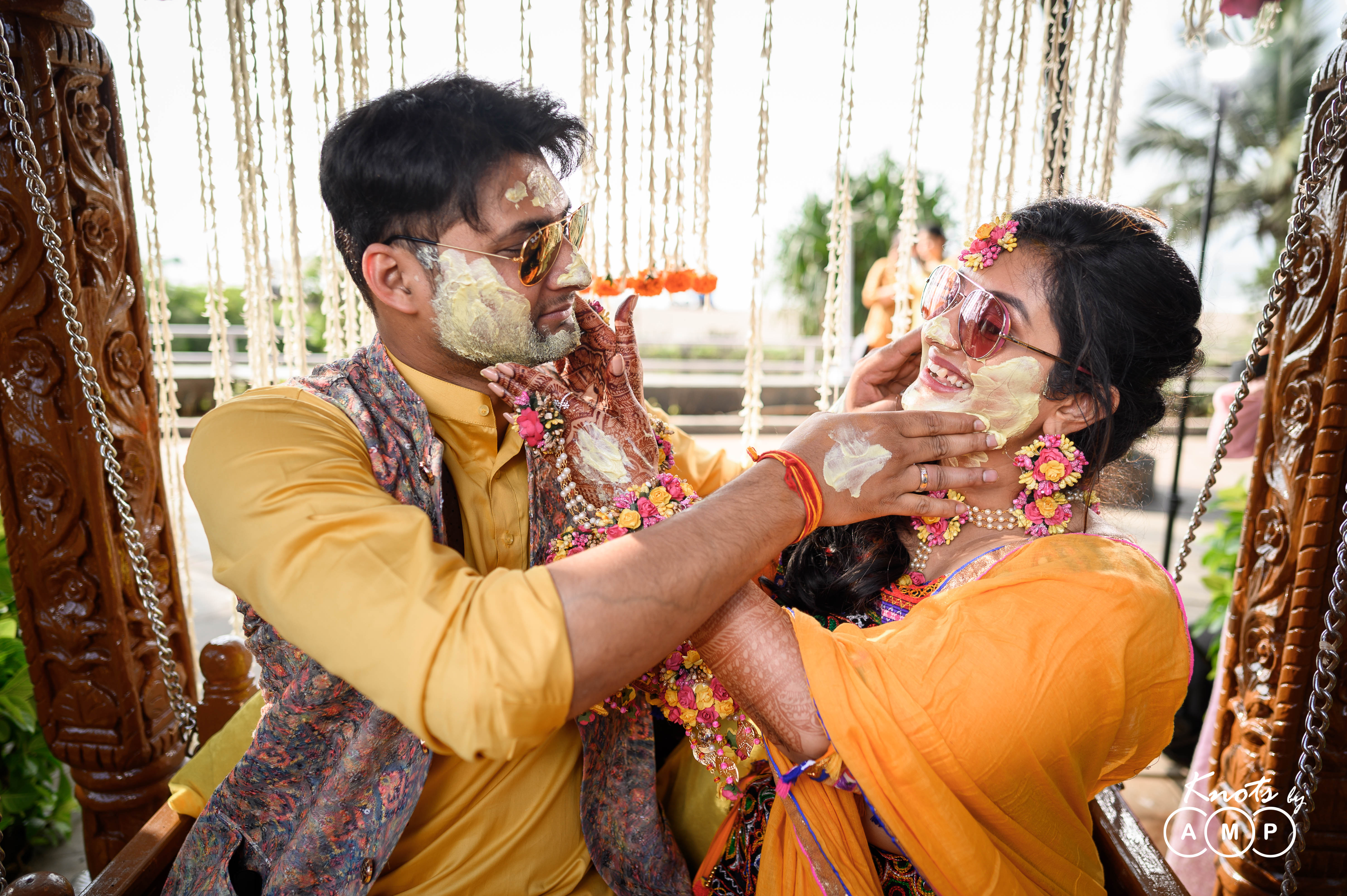 bride inorange lehenga with pom poms