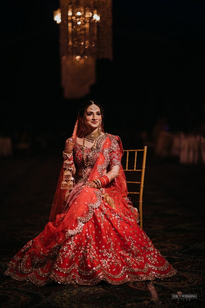 A Stunning Bride In Red Lehenga With Scalloped Edge Dupatta