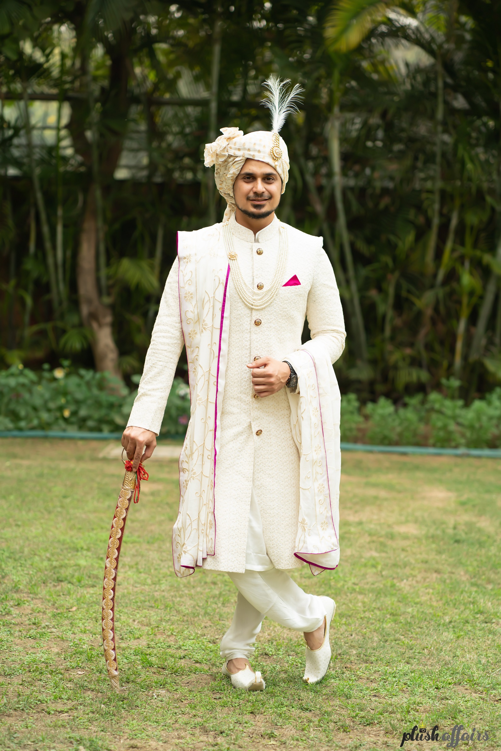 groom in white sherwani