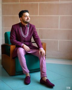 groom wearing purple sherwani