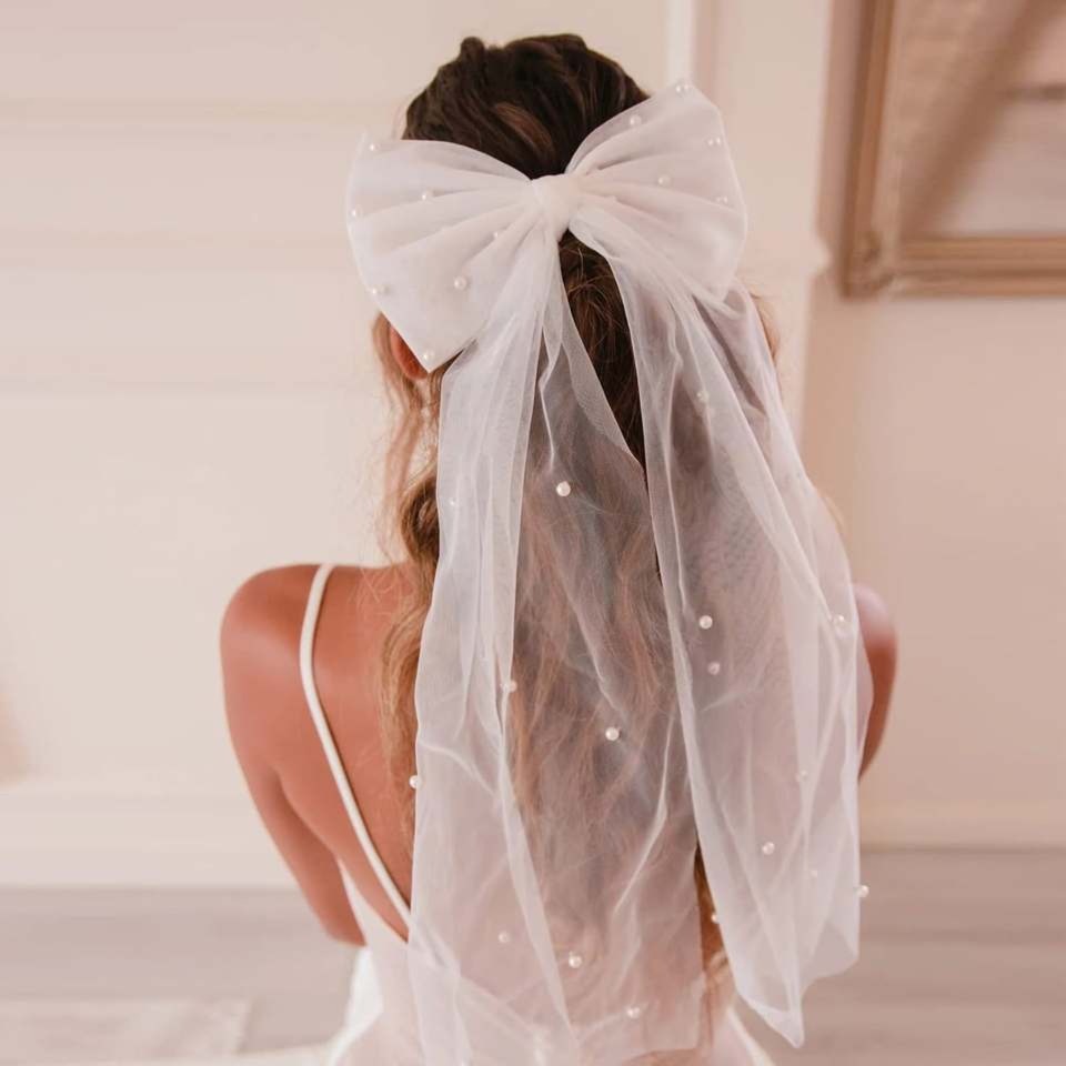 Wedding Trend Alert: Bows Are Here To Rule 2024 Bridal Hairstyles